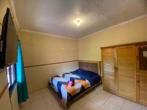 Ένα ή περισσότερα κρεβάτια σε δωμάτιο στο Poeri Sang Begawan