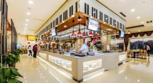 a grocery store with people standing around a counter at Yitel Tai'an Taishan Hongmen Daimiao in Tai'an