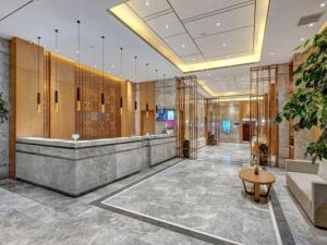 a lobby with a reception desk in a building at Yitel Collection Harbin Railway Station Museum Metro Station in Harbin