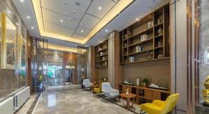 a lobby with chairs and a table in a building at Yitel Collection Harbin Railway Station Museum Metro Station in Harbin
