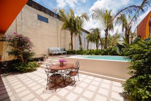 a patio with a table and chairs next to a pool at Amador by Suasana Villa in Jarakan