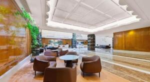 a lobby with a table and chairs in a building at Lake Piedmont International Hotel in Guangzhou