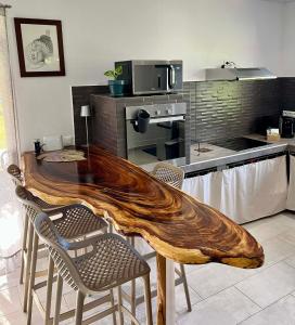 a kitchen with a wooden table and some chairs at Fare Araea in HUH