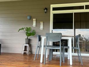 a table and chairs on a porch with a window at Fare Araea in HUH +7 photos