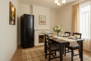 a dining room with a table and a black refrigerator at Workington Haven - 3 Bed Home in Workington
