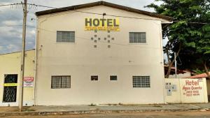 a white building with a hotel sign on it at Pousada Agua Quente in Rio Quente