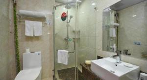 a bathroom with a toilet and a sink and a shower at GreenTree Inn Anhui Yaohai District MingGuang Road Bus Station Express Hotel in Hefei