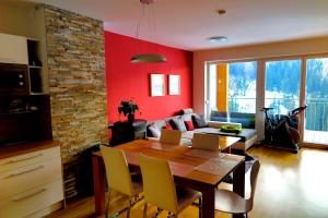 a living room with a table and a couch at Appartements Nassfeld LUX in Sonnenalpe Nassfeld