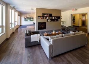 a living room with two couches and a fireplace at HI Whistler - Hostel in Whistler