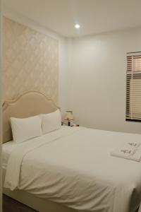 Ένα ή περισσότερα κρεβάτια σε δωμάτιο στο The Serenity Residence Ha Noi