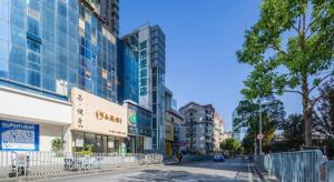 a street in a city with tall buildings at City Comfort Inn Wuhan Wansongyuan Wangjiadun East Metro in Wuhan