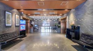 a lobby with benches and a bar in a building at Yitel Beijing Tuanjiehu Metro Station in Beijing