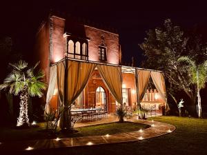 a large brick building with a table in front of it at Villa Dar Al Hayat in Marrakesh