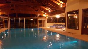 a large swimming pool in a building with at Costa Brava Apart Hotel & Suites in San Carlos de Bariloche +61 photos