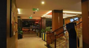 a lobby with a staircase in a building at Jelita Bandara Hotel Airport in Ulin +101 photos