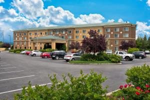 a large building with cars parked in a parking lot at Oxford Suites Spokane Valley in Spokane Valley
