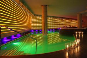 a swimming pool with lights in a building at Cristal Palace Hotel in Madonna di Campiglio