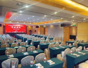 a conference room with blue tables and chairs and a screen at Vienna International Shenzhen Tianan Digital City in Longgang