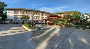 a parking lot in front of a large building at CK Hills Hotel in Mae Sot