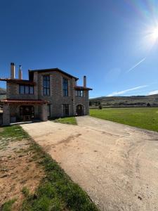 an old stone house on a dirt road at Armonia Suites Livadi Arachovas in Arachova