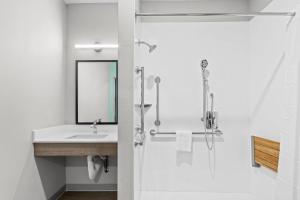 a bathroom with a sink and a shower at Echo Suites Extended Stay by Wyndham Atlanta-Conyers in Conyers +25 photos