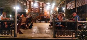 a group of people sitting at tables in a restaurant at Tadangbay bungalow in Koh Chang Ranong