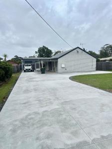 a garage with a car parked in a driveway at The Burra Spa, Games & Beach House in Culburra Beach +17 photos