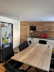 a conference room with a wooden table and chairs at Landhaus im Feld in Sankt Michael im Lungau