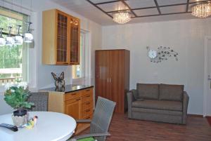 a living room with a table and a chair at Koivikko in Kangasala