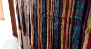 a bunch of colorful ties hanging on a wall at Guilin Lotus Hotel in Guilin