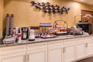 a kitchen with a counter with food on it at Inn of The Dove Romantic Luxury & Business Suites in Bensalem