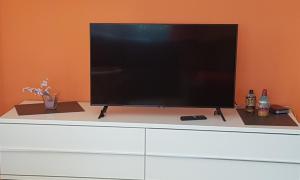 a large flat screen tv sitting on top of a dresser at Ferienwohnung Bär in Schwäbisch Hall