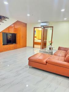 a living room with a couch and a television at Cacua villa 6 bedrooms in Phu Quoc +32 photos