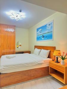 a bedroom with a large bed with white sheets at Cacua villa 6 bedrooms in Phu Quoc