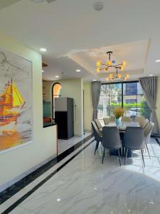 a dining room with a table and chairs and a kitchen at Cacua villa 6 bedrooms in Phu Quoc