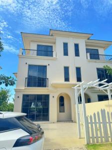 a white house with a car parked in front of it at Cacua villa 6 bedrooms in Phu Quoc