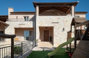 a house with a playground in front of it at Luxury Villa San heated pool sauna in Sveti Filip i Jakov