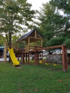 a wooden playground with slides and a gazebo at Timber Pointe Resort in Jamestown