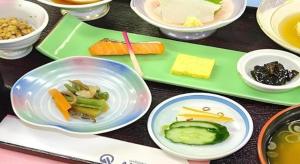 a table with plates of food and bowls of food at Hotel Abest Aomori in Aomori