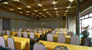 a conference room with yellow tables and white chairs at Tsukino Sumika Atami Juraku Hotel in Atami +193 photos