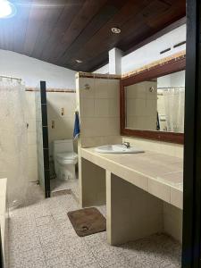 a bathroom with a sink and a mirror and a toilet at Uncle Matts Cafe and Chill in Chiang Mai +15 photos