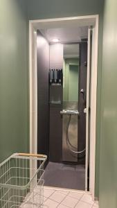 une salle de bain avec une douche avec une porte vitrée dans l'établissement Book Tea Bed SHIBUYA, à Tokyo