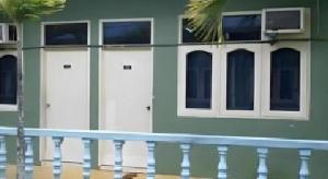 a building with three white doors and a fence at Mawanza Hotel Langkawi in Langkawi Islands +65 photos
