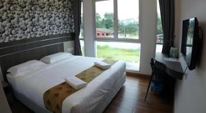 Ένα ή περισσότερα κρεβάτια σε δωμάτιο στο HOTEL KAWAN BIDOR