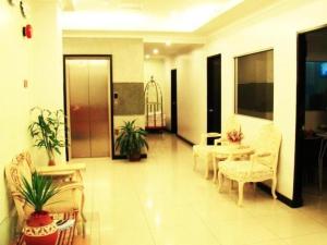 - un salon avec des chaises et une table dans un bâtiment dans l'établissement Adel Hotel, à Putatan