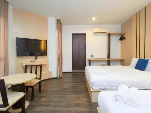 a hotel room with two beds and a flat screen tv at Grand Kapar Hotel Klang Sentral in Setia Alam