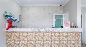 a room with a counter with a vase of flowers at Moment Hotel in Kampong Bukit Lanjan +106 photos