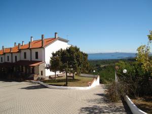 a house on a hill with a view of the ocean at Solaire Valentano in Valentano