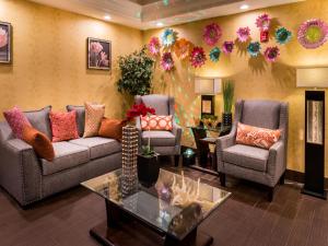 a living room filled with furniture and decorations at Inn of The Dove Romantic Luxury & Business Suites in Bensalem