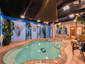 a large swimming pool in a building at Inn of The Dove Romantic Luxury & Business Suites in Bensalem